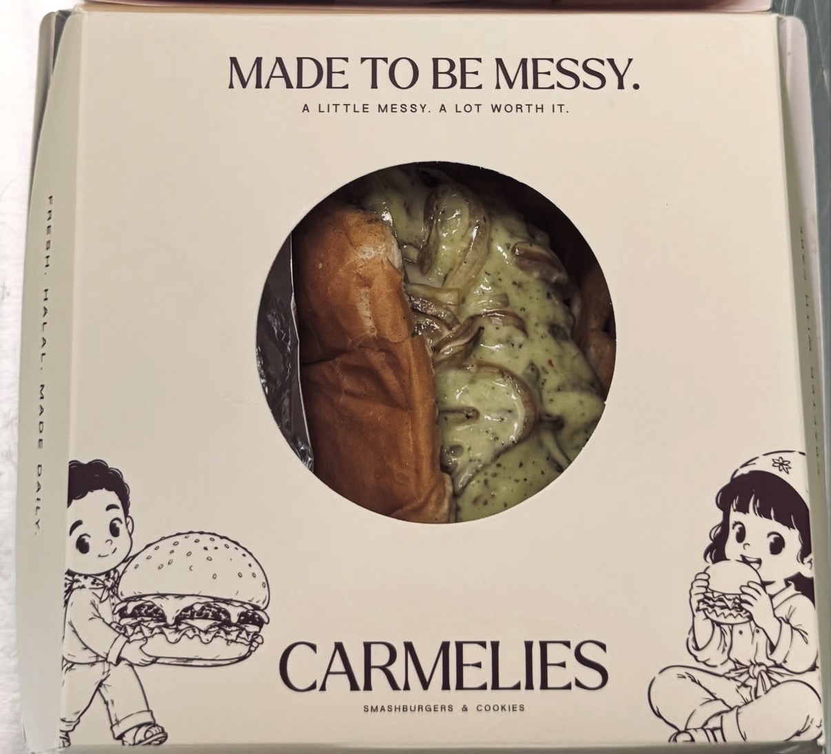 Carmelies cream box reading Made to be messy with a saucy smashburger in the window
