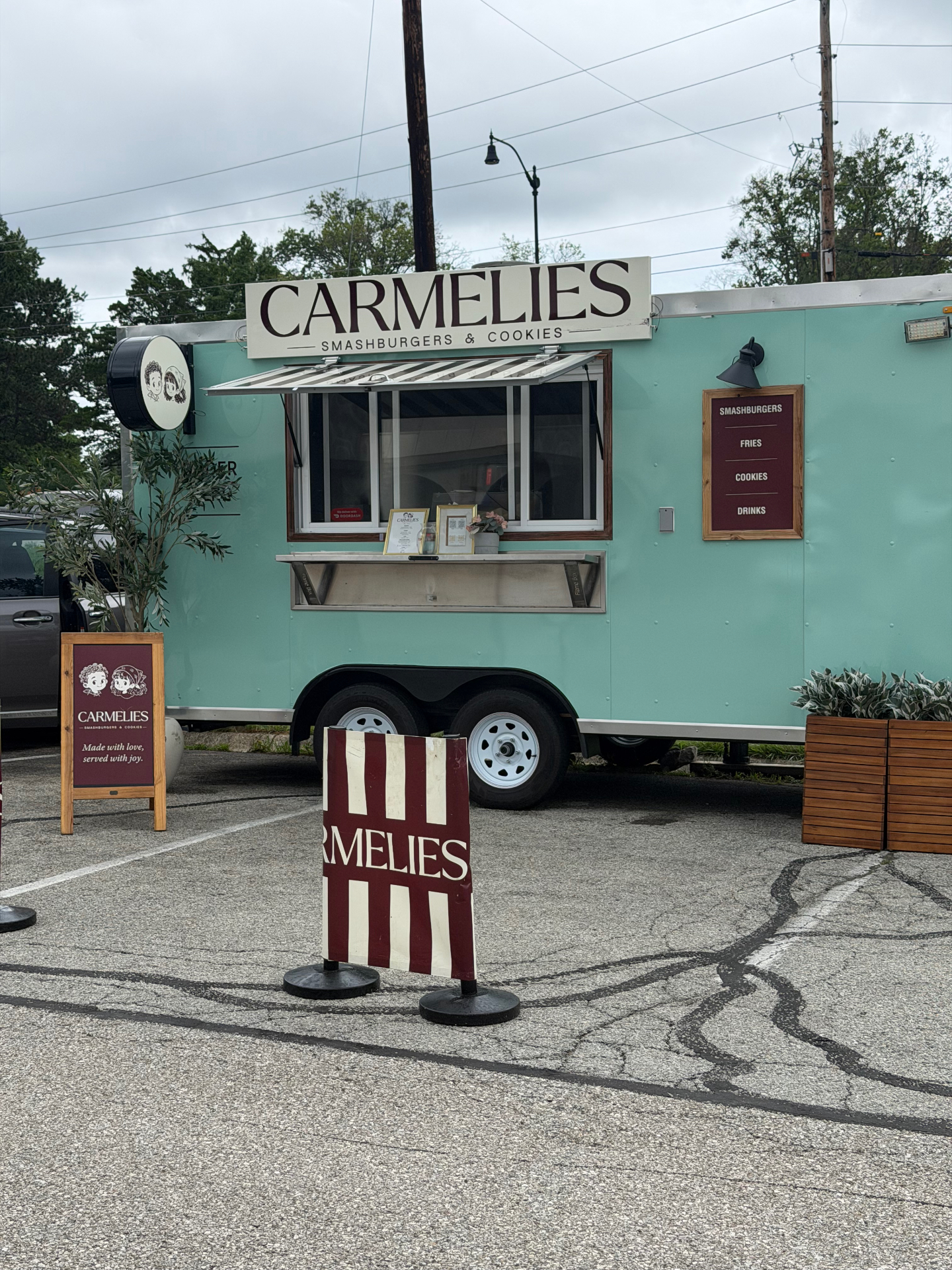 The mint green Carmelies food truck with its service window open